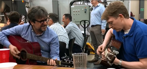 Turkish Dealer Mengu Arslanoglu and Thermwood's Duane Marrett playing guitar at the 2019 Thermwood Dealer Conference Awards Dinner