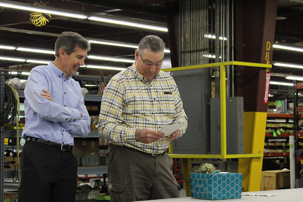 David and Rich reading a card signed by all employees at Thermwood.